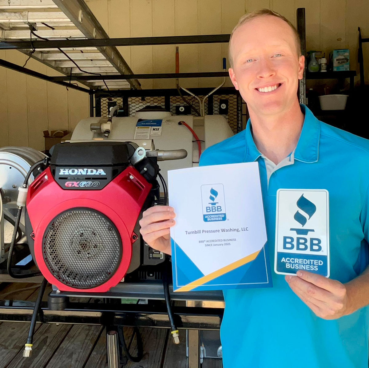 your local pressure washer, Jacob Turnbill, holding BBB accreditation information