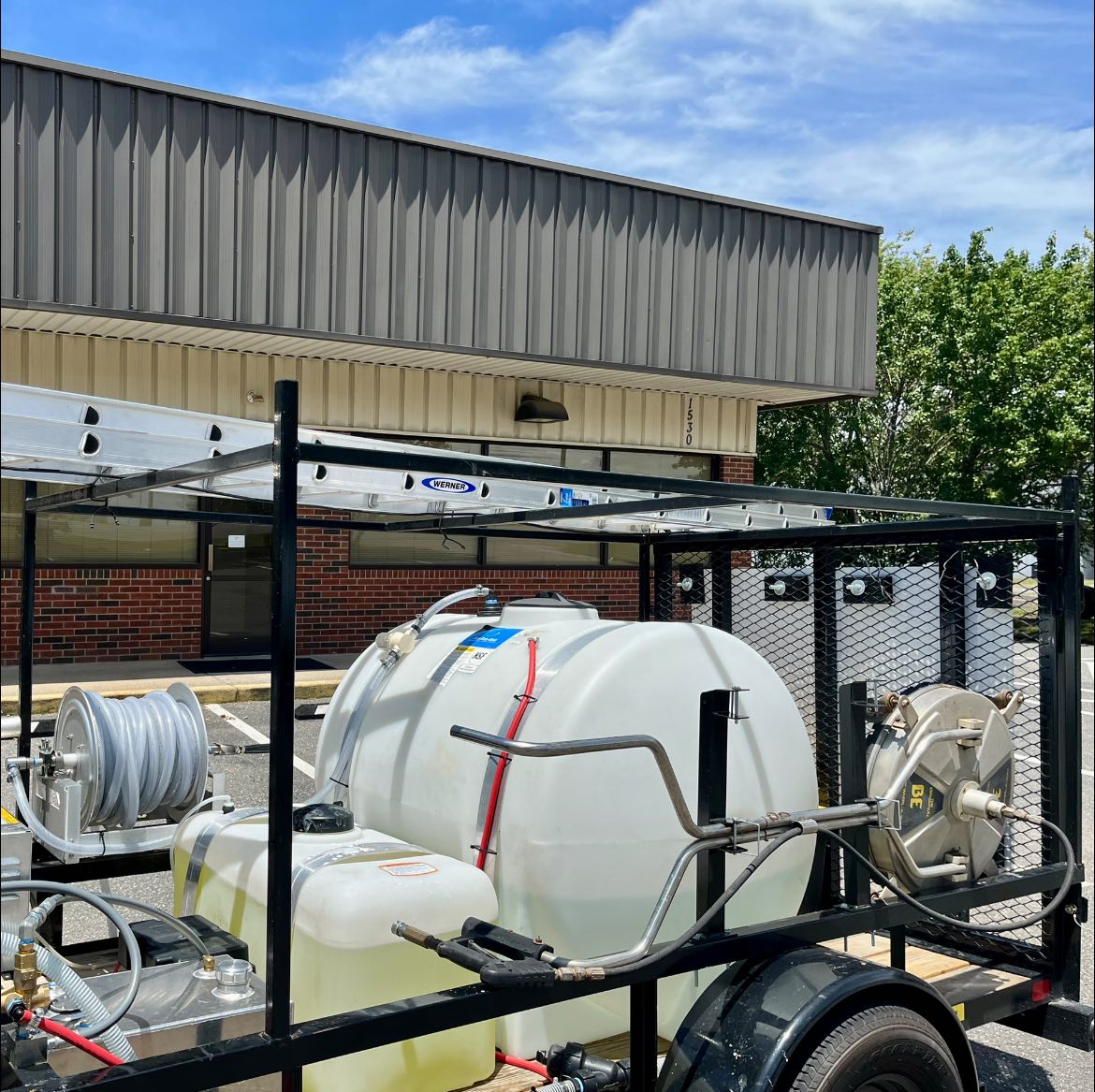 pressure washing equipment in front of a commercial building